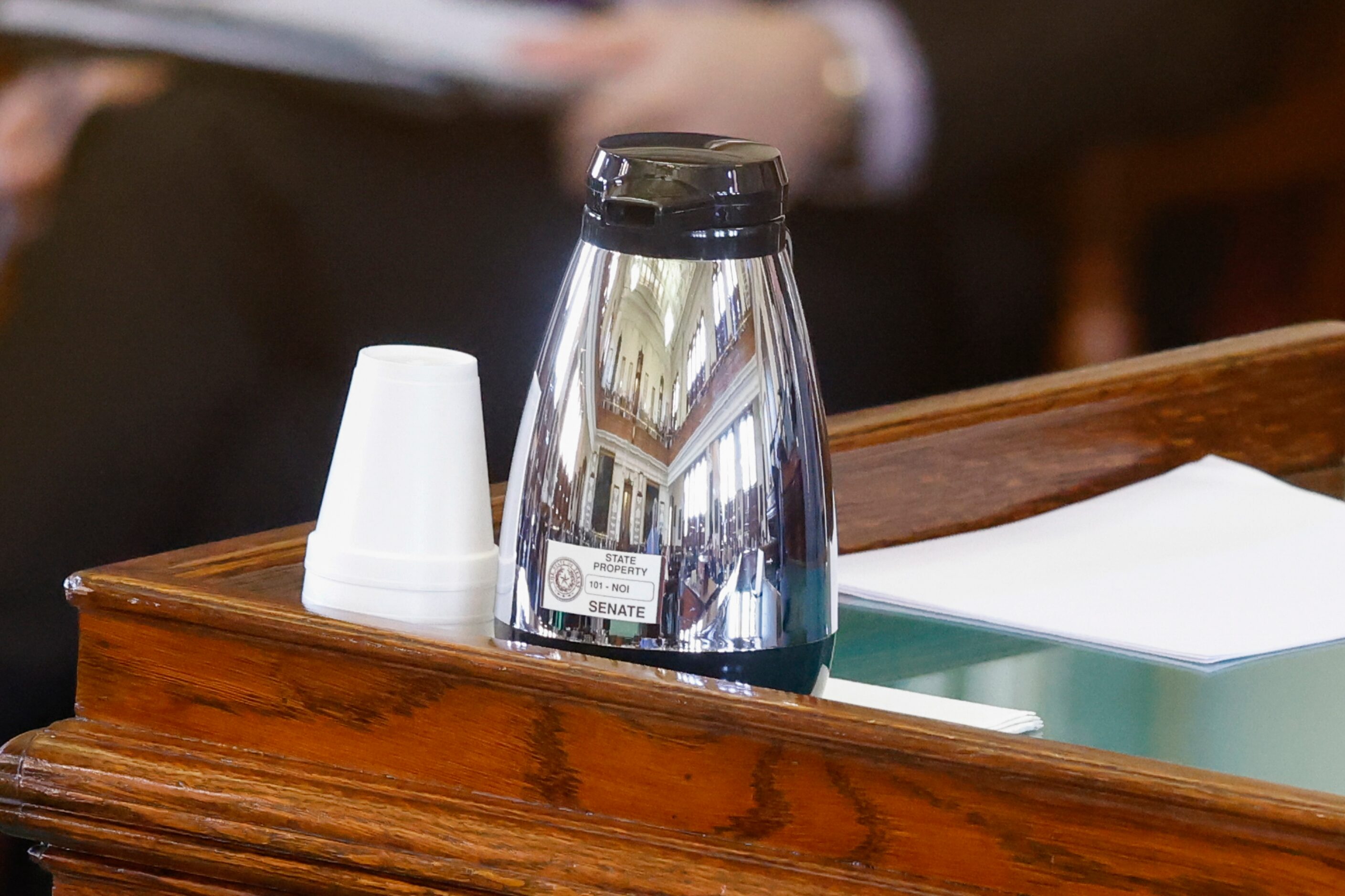 The Senate chamber reflected on a metal carafe during the third day of Texas Attorney...