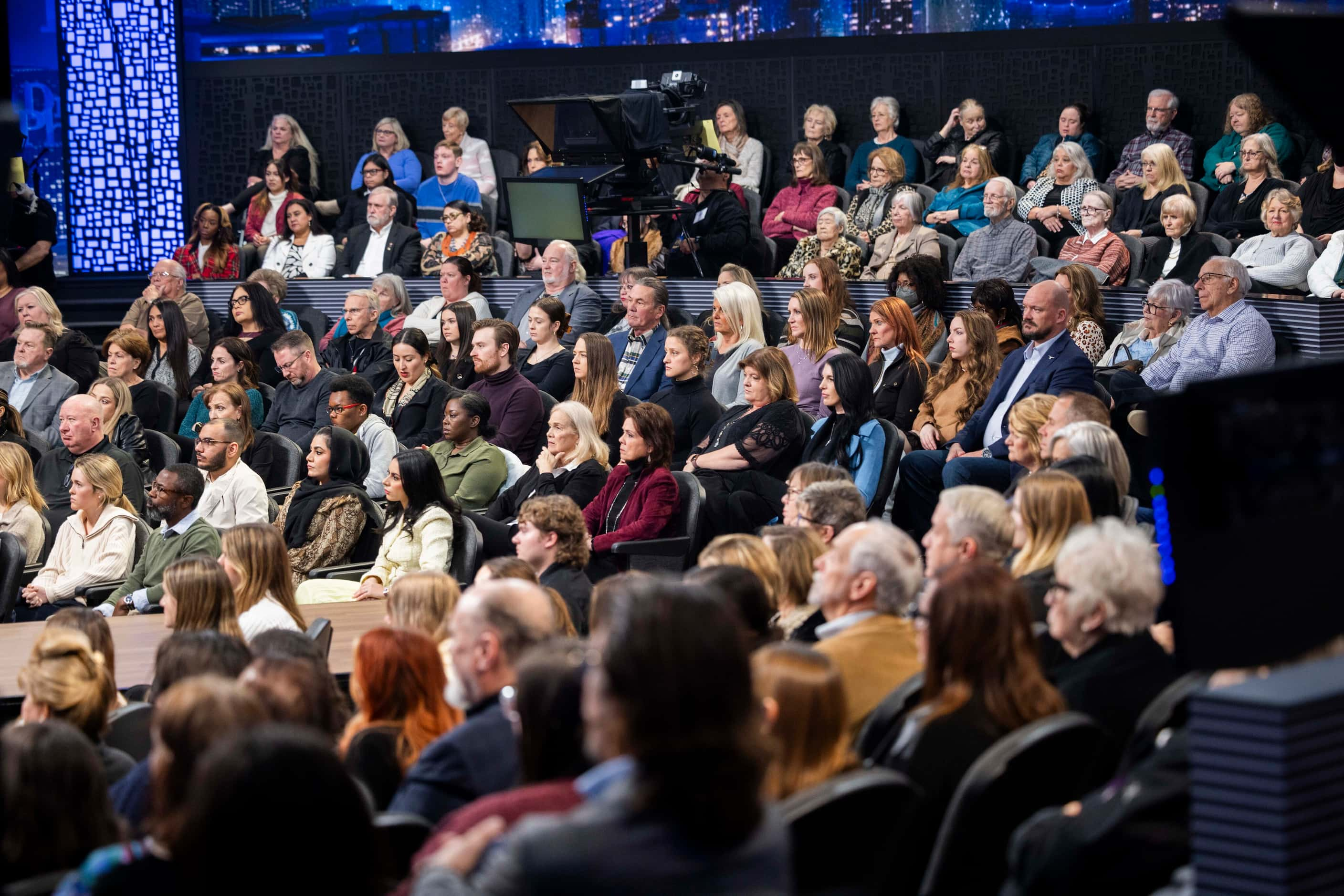 A studio audience listens as Phil McGraw, better known as Dr. Phil, discusses sextortion...