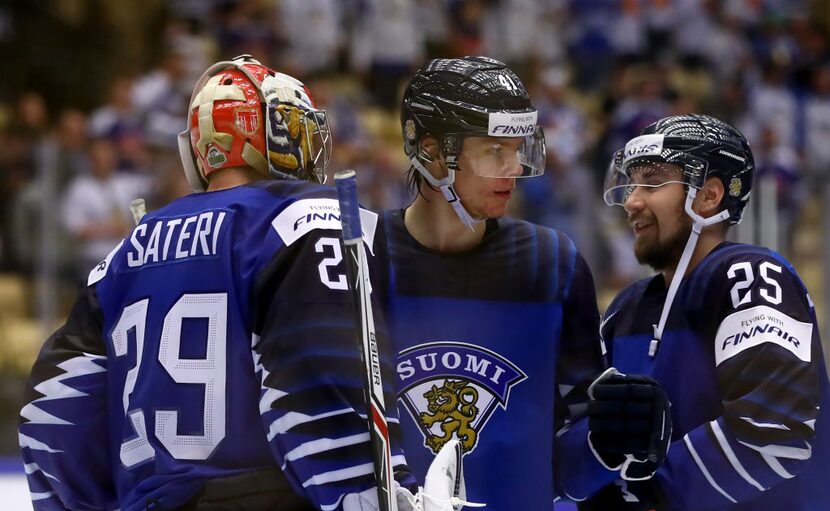 HERNING, DENMARK - MAY 08: Harri Sateri, goaltender of Finland celebrate with his team mates...