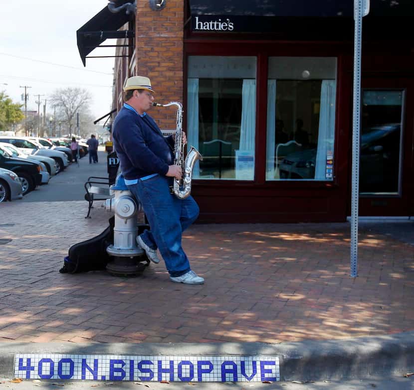 
Christopher Brown played his saxophone for passers-by in the Bishop Arts District Friday...