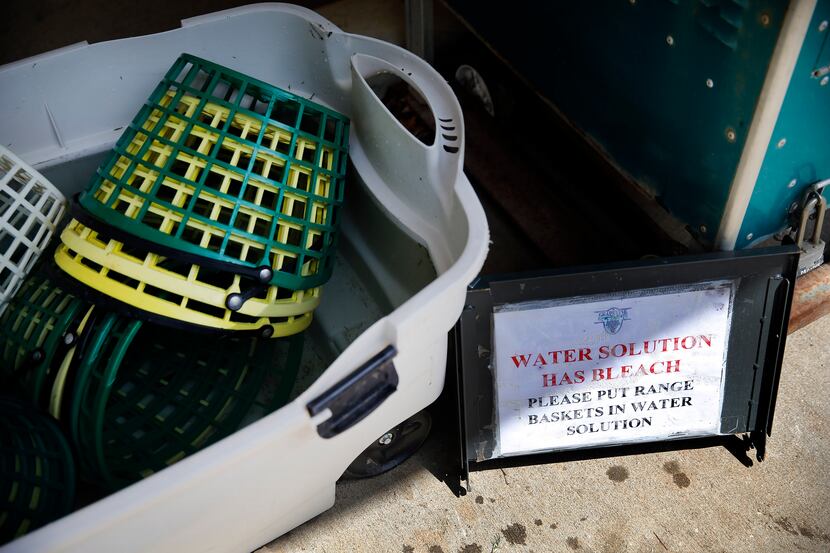 Since reopening, the range ball baskets soak in bleach water to prevent coronavirus spread...