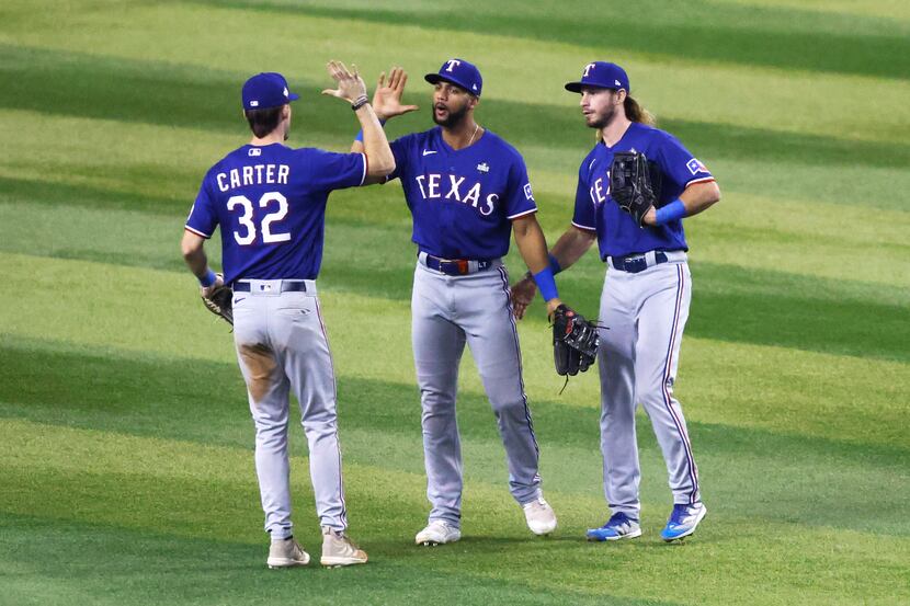 Texas Rangers left fielder Evan Carter (32), center fielder Leody Taveras (center) and right...