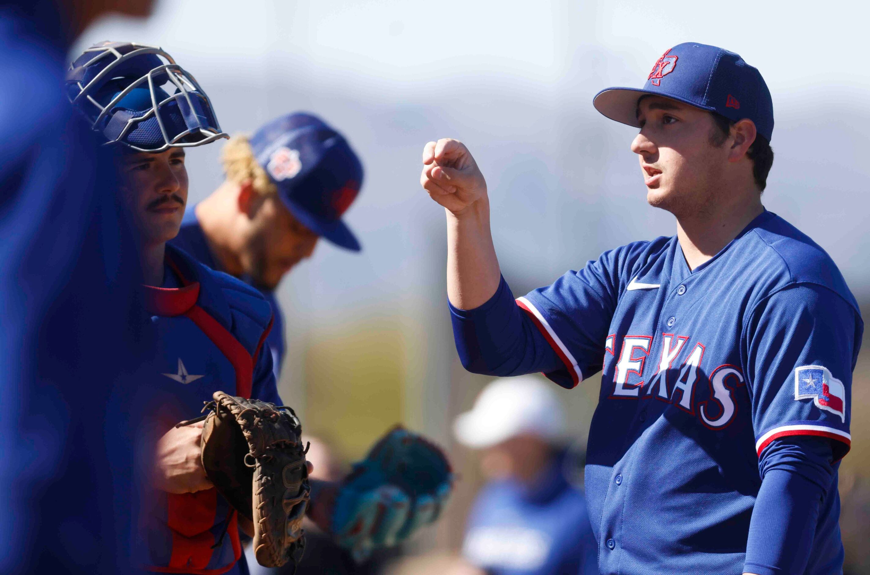 Texas Rangers right handed pitcher Owen White interacts with teammates during the first...