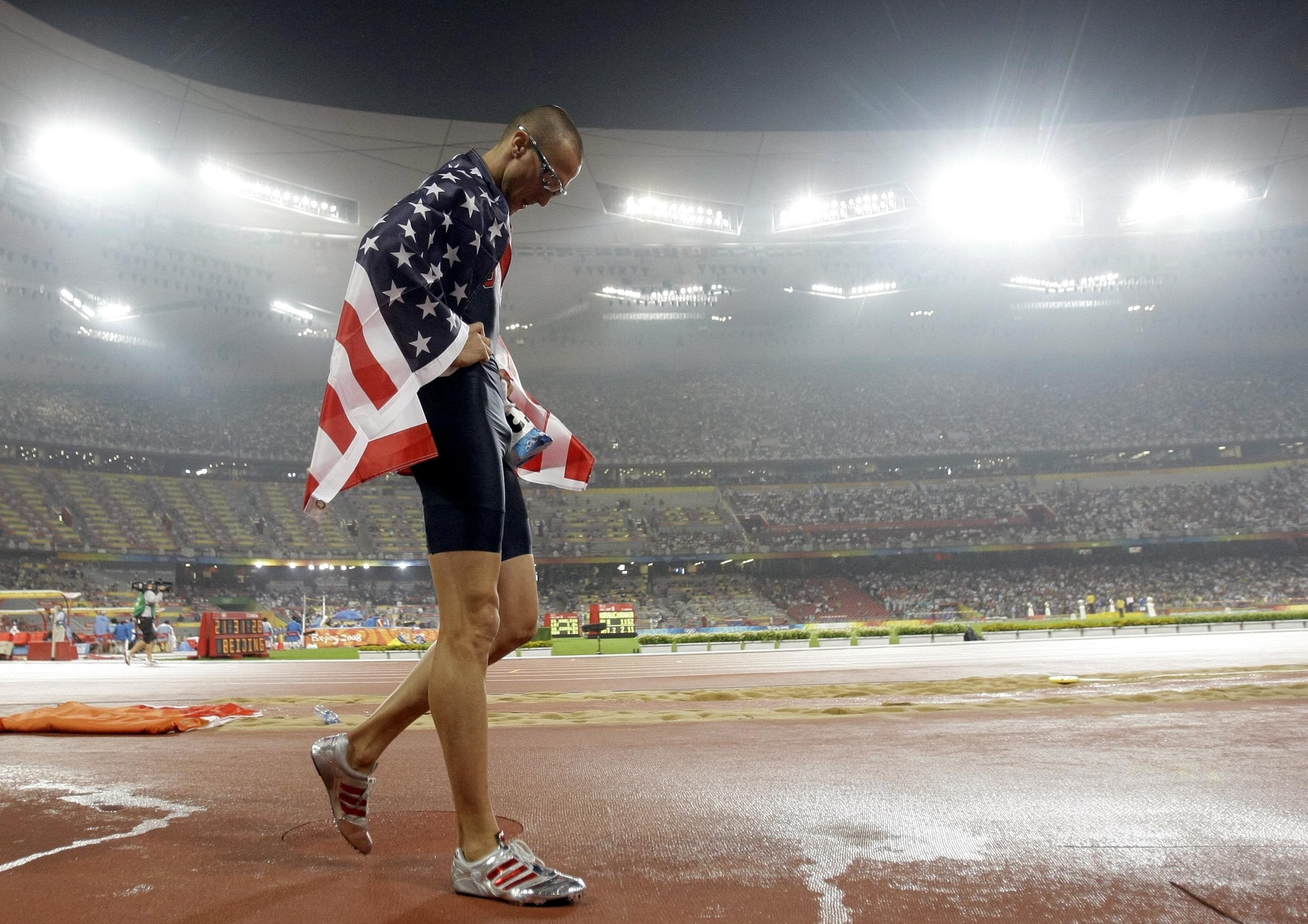 2008 Beijing Olympics: Silver medalist Jeremy Wariner walks around the National Stadium...