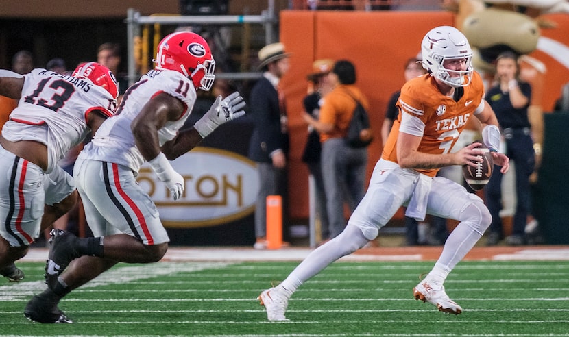 Texas quarterback Quinn Ewers (3) is chased out of the pocket by Georgia defensive lineman...