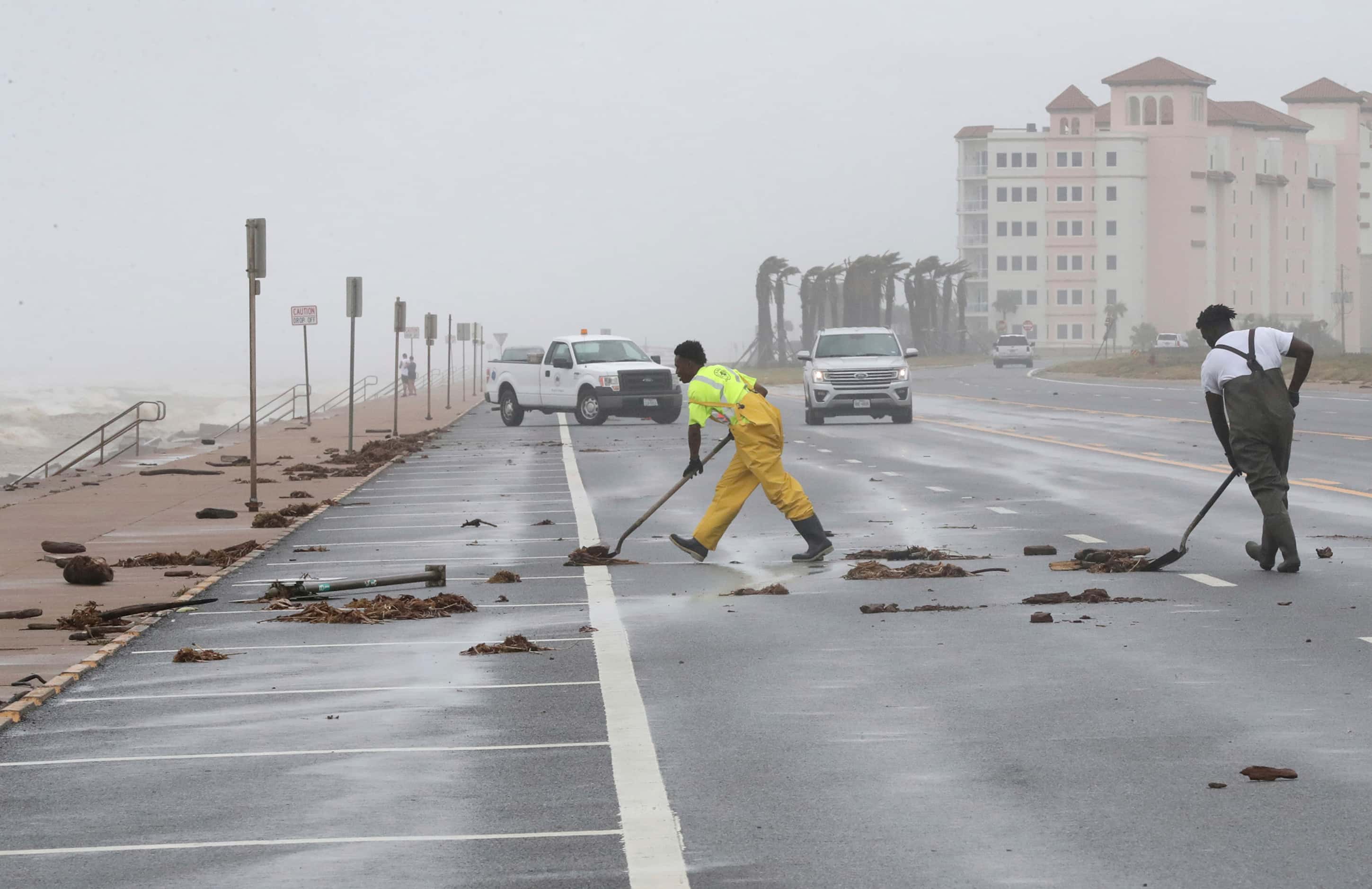 City of Galveston workers clear debris from Beryl from the West End of the seawall in...