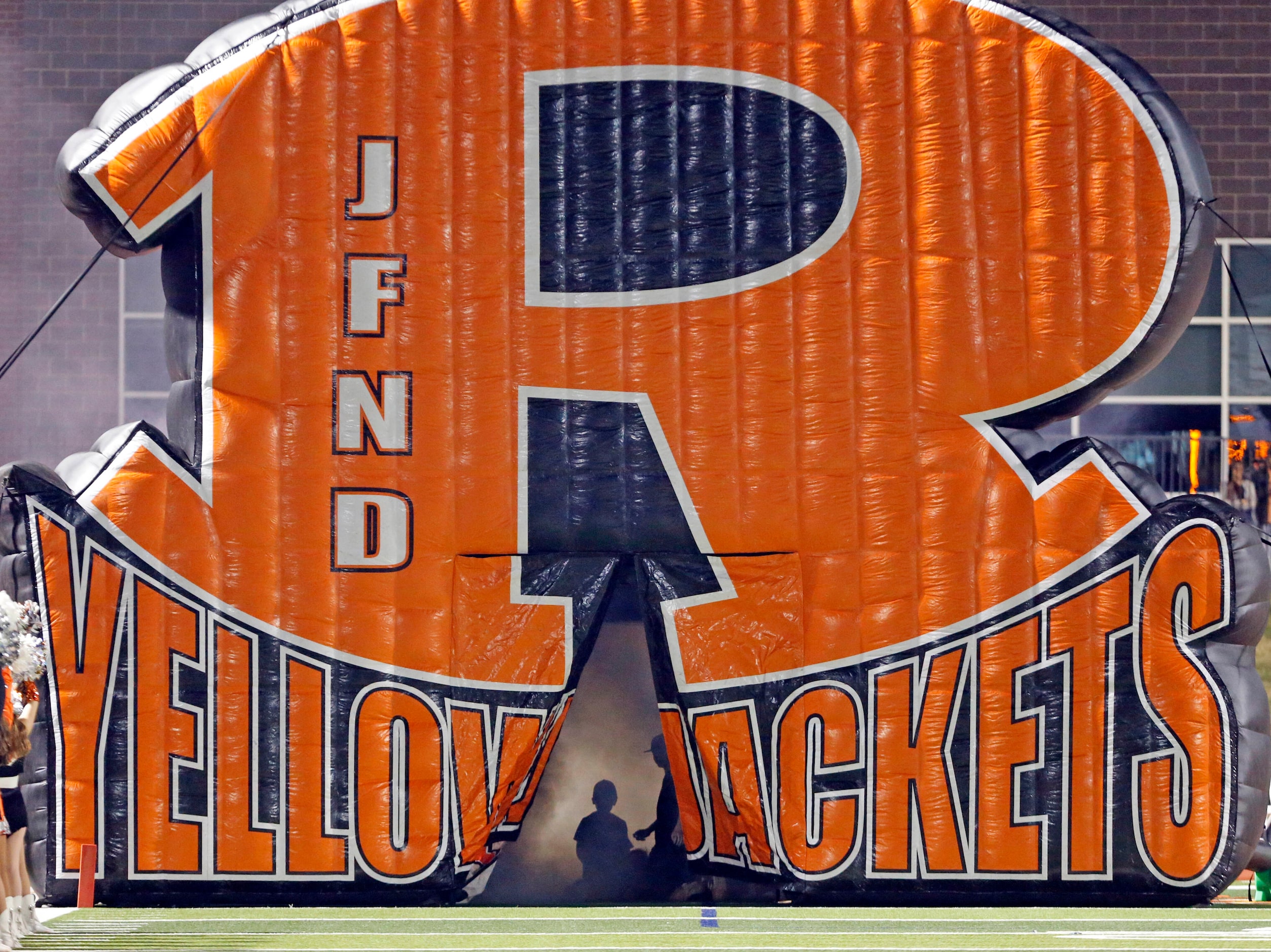 A couple of kids play inside Rockwall high’s smoke-filled run-through blowup before the...