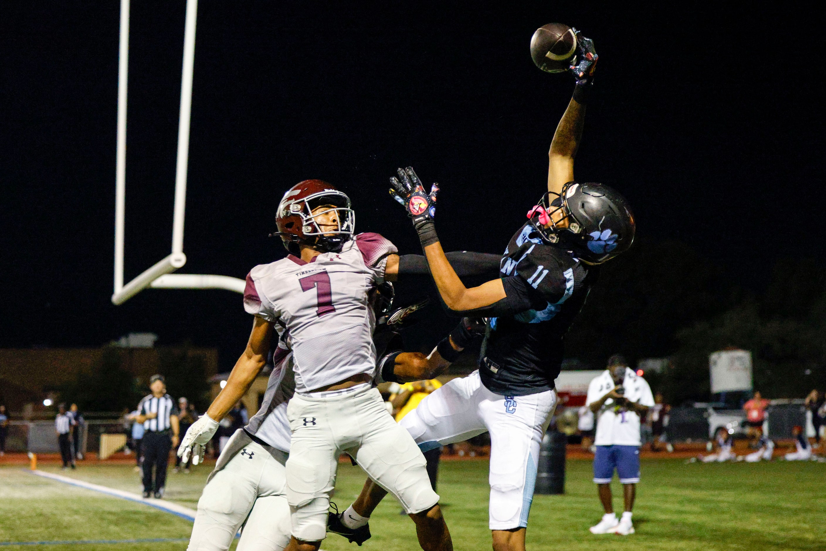 Arlington Seguin wide receiver Carterrious Brown (11) makes a leaping catch over Mansfield...