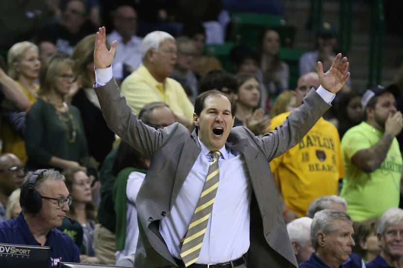Baylor head coach Scott Drew fires up the crowd after a score against West Virginia in the...