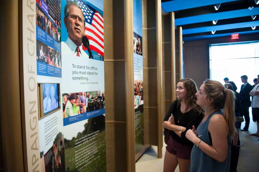 Two young women looking at a display at the Bush Center on the SMU campus.