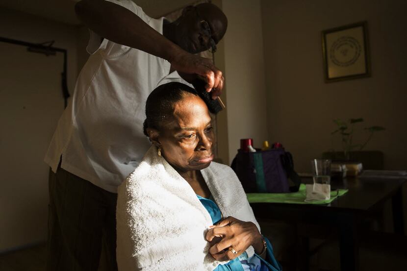 Herbert fixes his wife's hair at their apartment in Dallas. "He's a part of my life that...