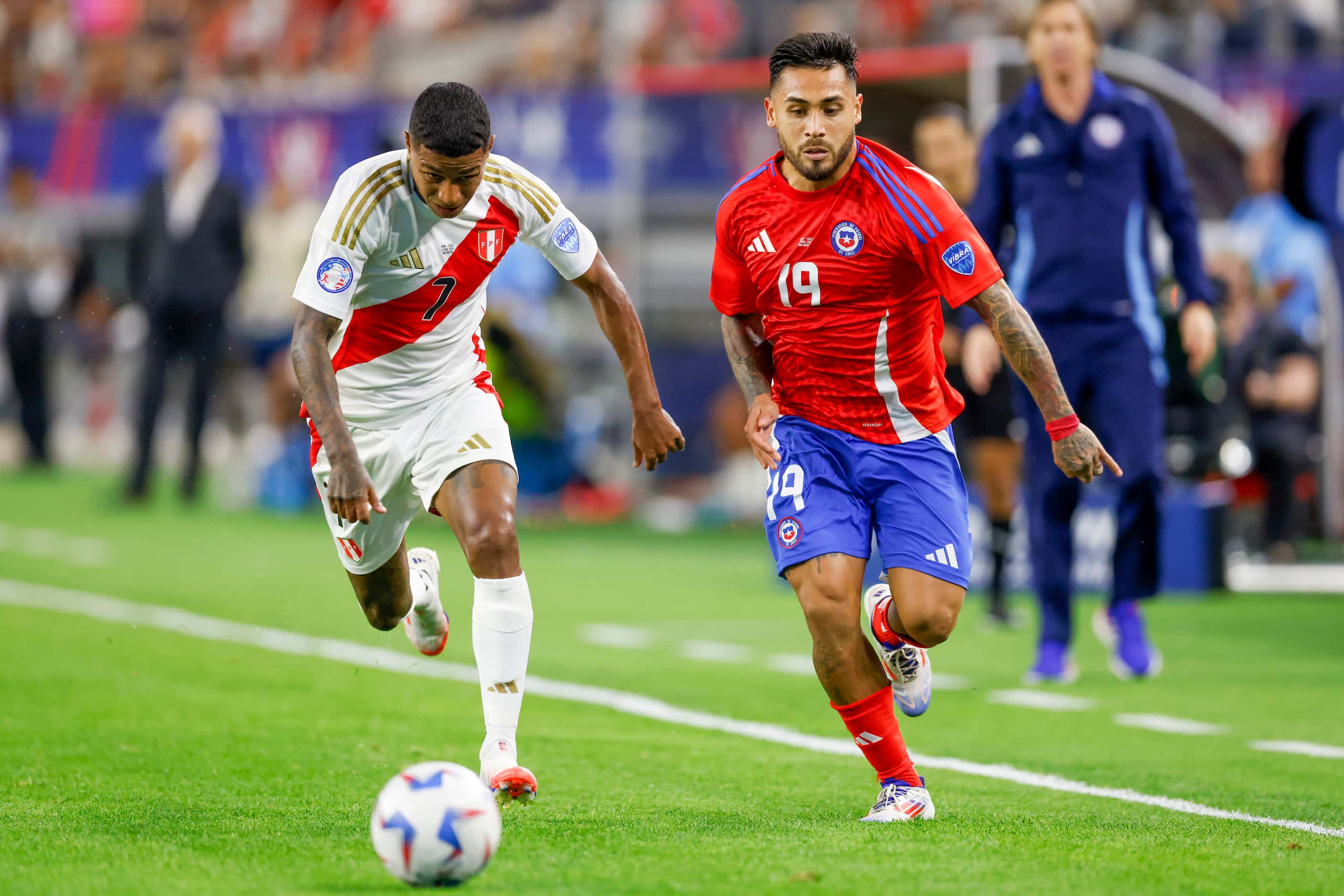 Chile forward Marcos Bolados (19) races down the field ahead of Peru forward Andy Polo (7)...