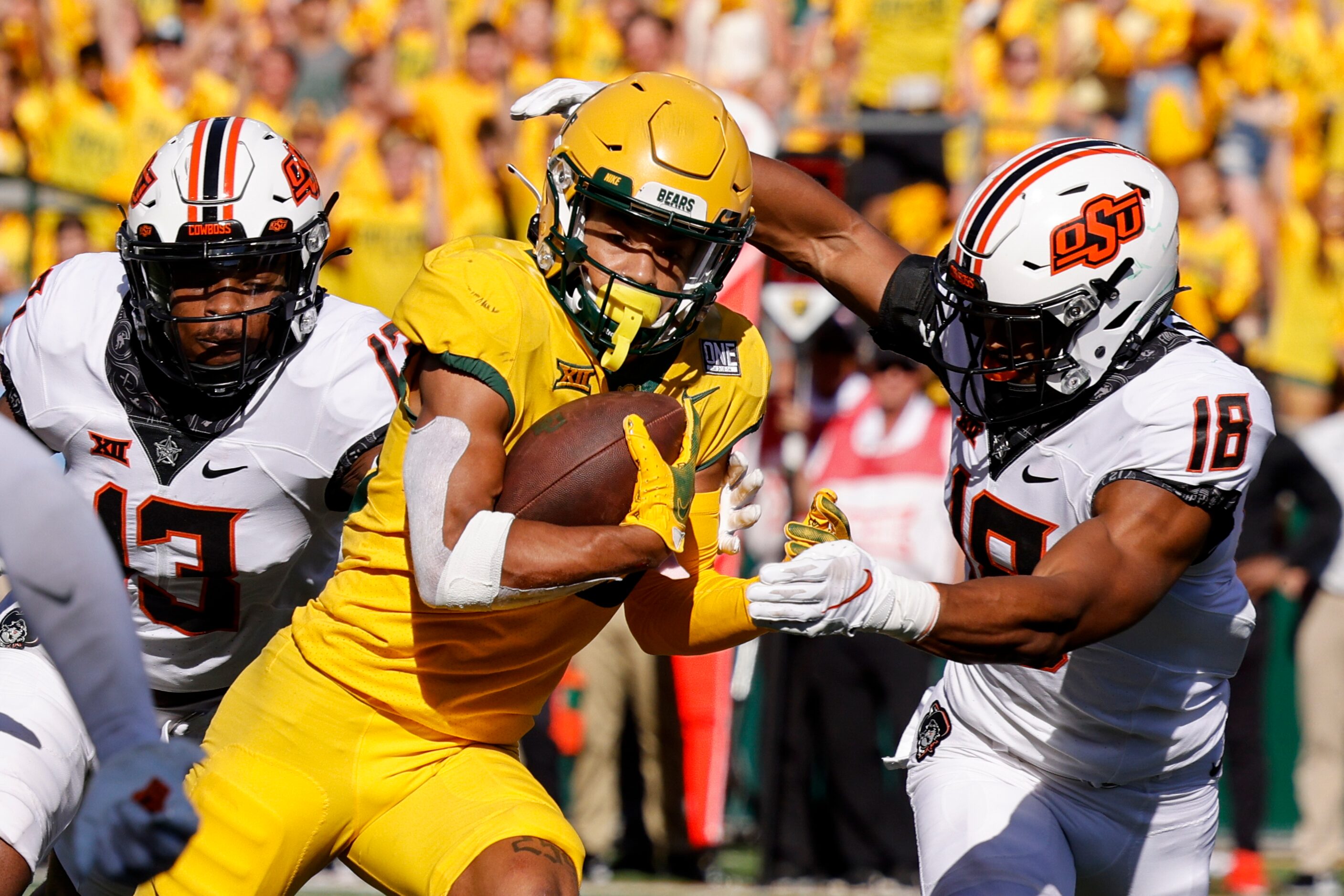 Oklahoma State safety Thomas Harper (13) and safety Sean Michael Flanagan (18) tackle Baylor...