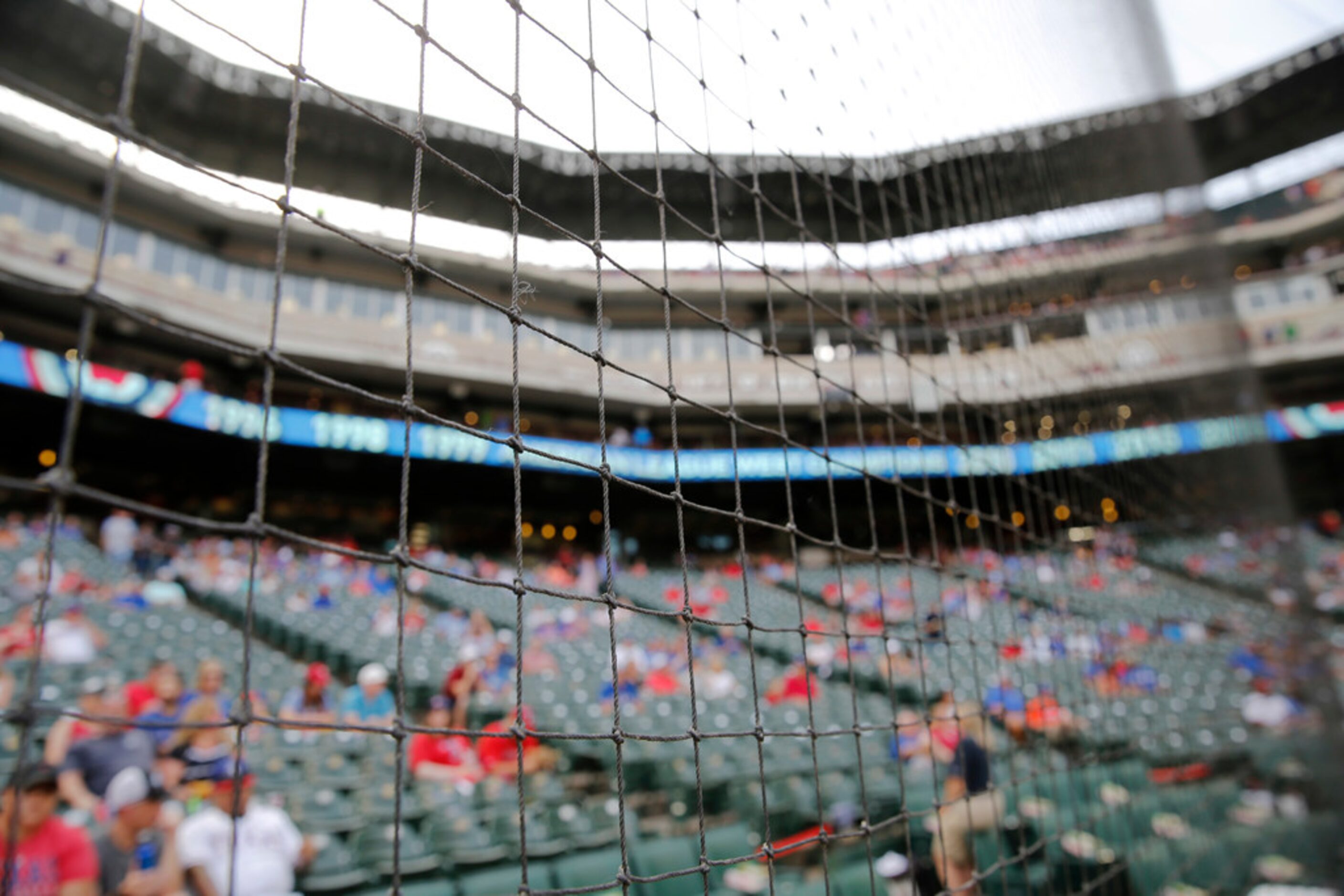 Protective netting seen before a game between the Texas Rangers and Kansas City Royals at...