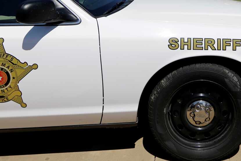 A Kaufman County Sheriff's patrol car drives by in front of the home of District Attorney...