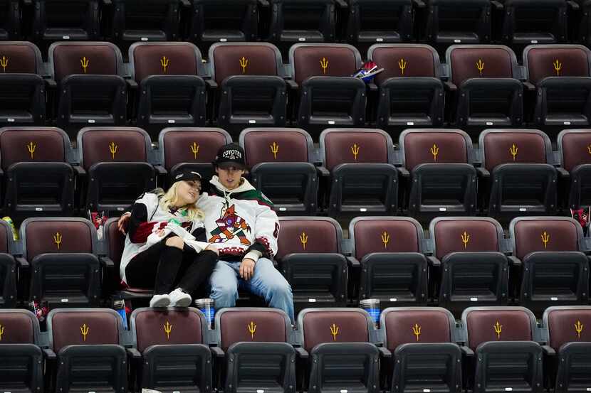 Arizona Coyotes fans sit in their seats long after the team's NHL hockey game against the...