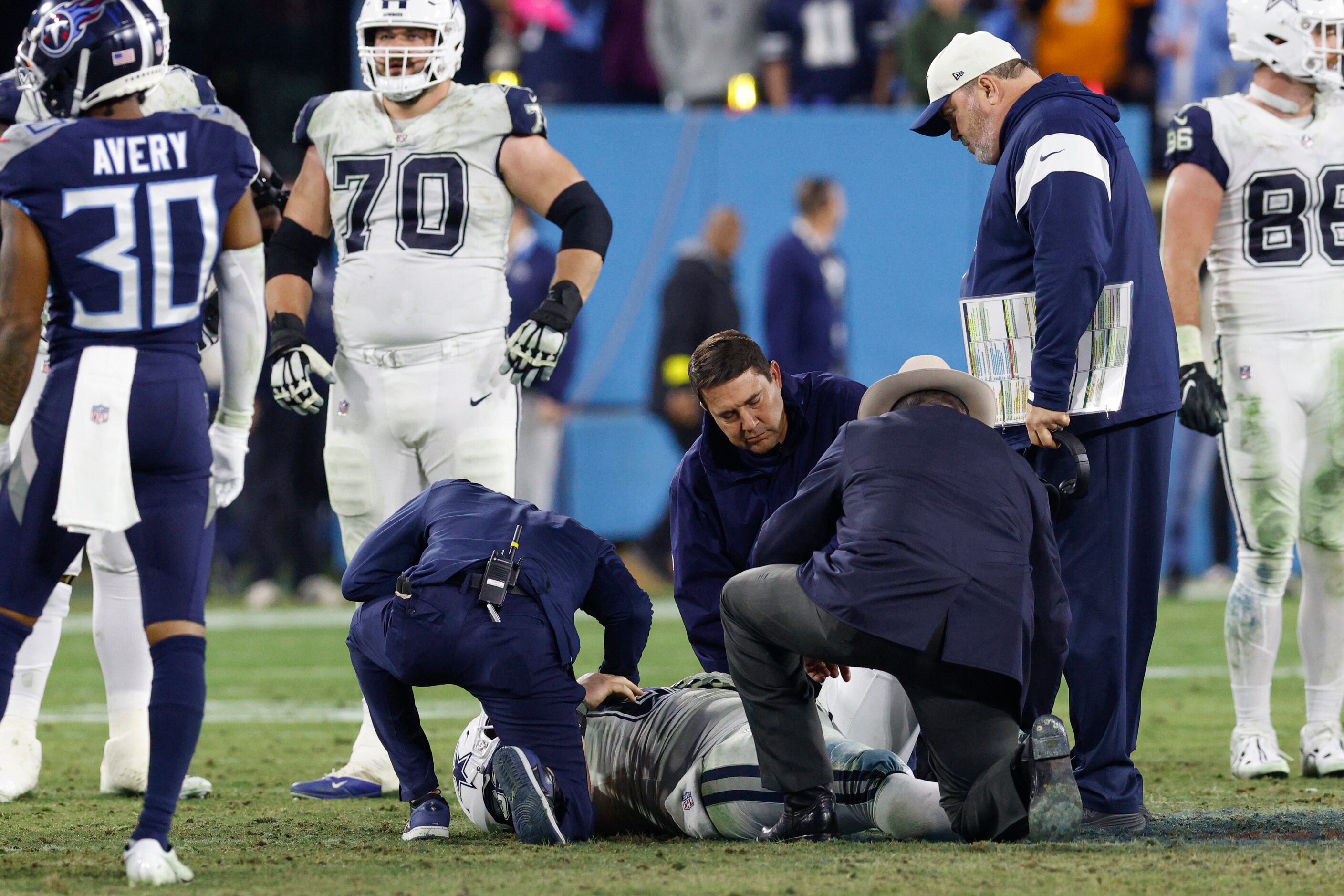 Dallas Cowboys head coach Mike McCarthy (right) watches as medical staff tend to an injured...