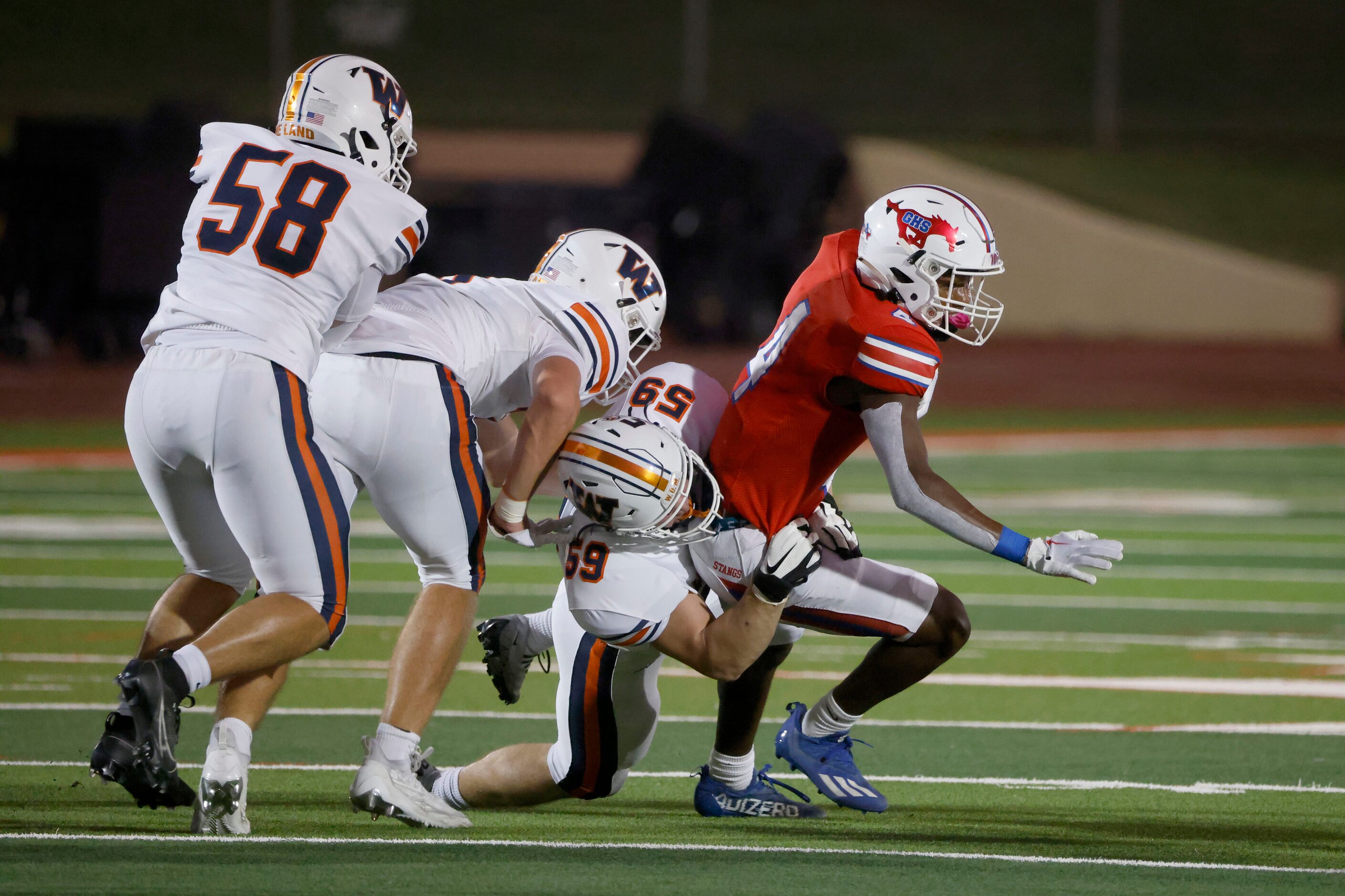 Frisco Wakeland’s Christian Guevara (58), Tristan Lawyer and Austin Wilson (59) tackle...