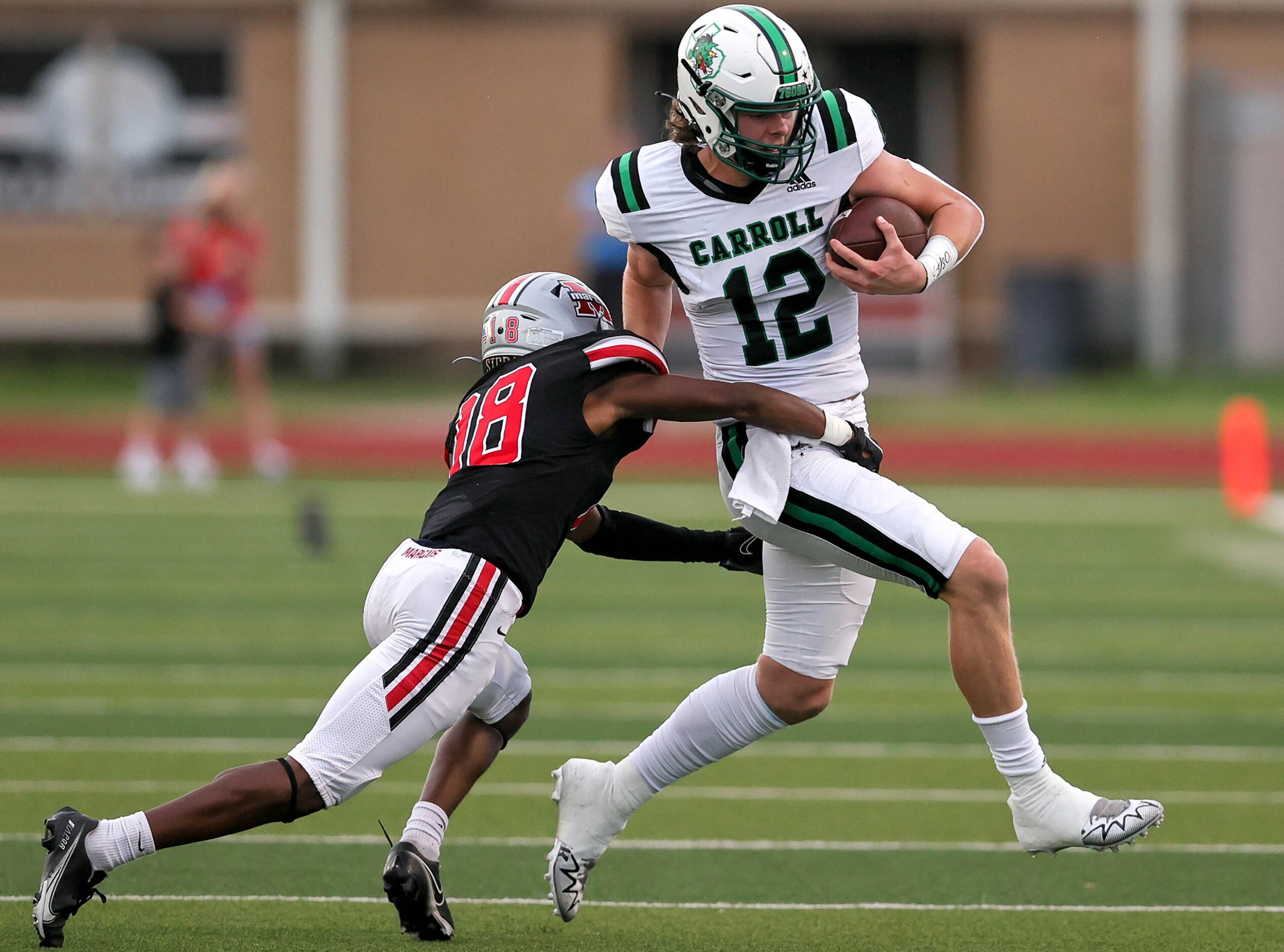 Southlake Carroll quarterback Kaden Anderson (12) tries to get over to the sideline against...