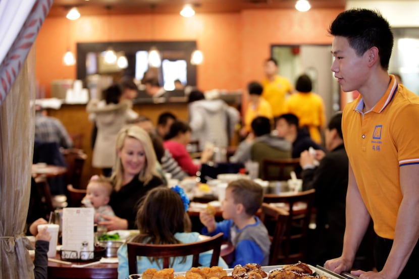 Calvin Zhang serves customers at J.S. Chen's Dim Sum and BBQ in Plano.