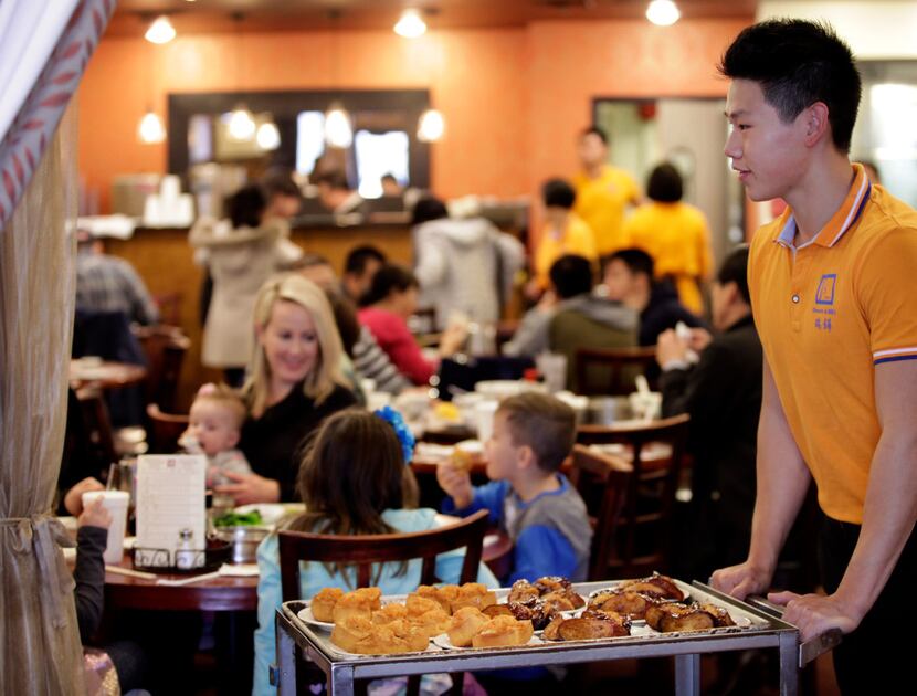 Calvin Zhang serves customers at J.S. Chen's Dim Sum and BBQ in Plano.