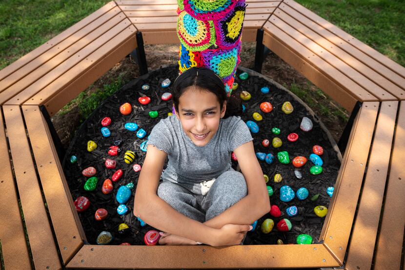 Anya Ali, 12, spearheaded a project to decorate a tree trunk with crochet for a new reading...