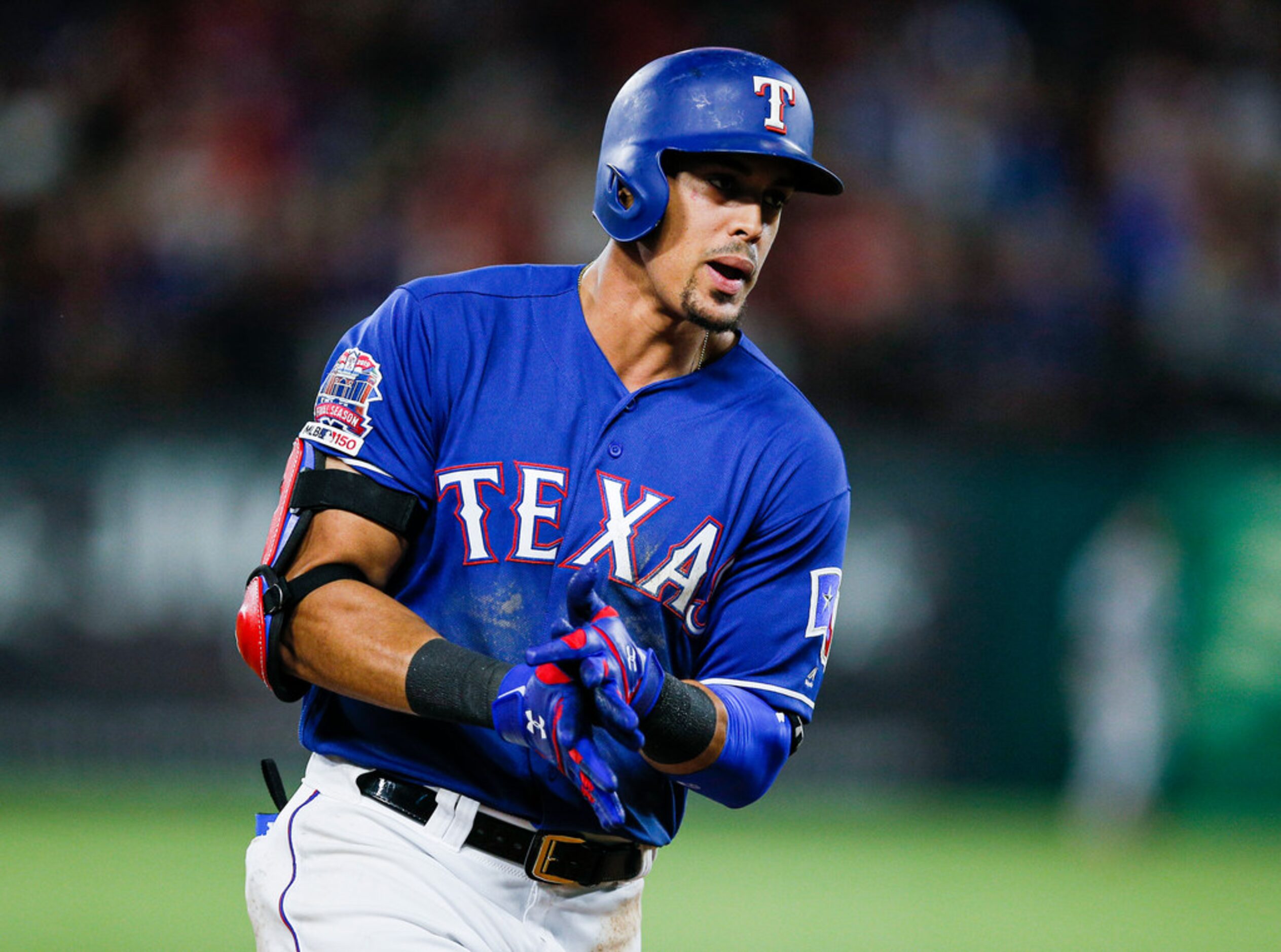 Texas Rangers' Ronald Guzman celebrates hitting a two-run home run during the eighth inning...