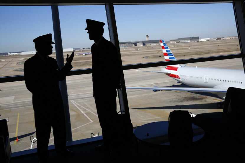 US Airways pilots visit before the newly painted American Airlines 777 following the press...