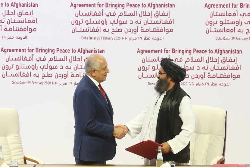 U.S. peace envoy Zalmay Khalilzad (left) and Mullah Abdul Ghani Baradar, the Taliban group's...