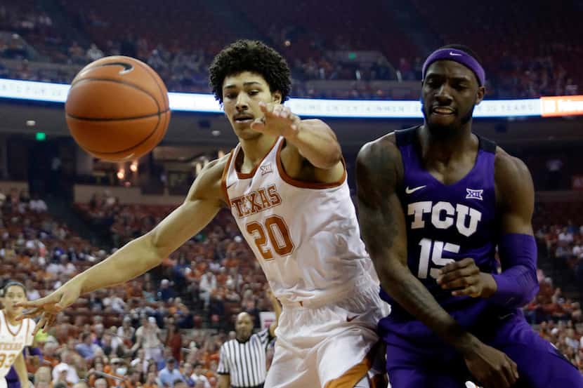 Texas forward Jericho Sims (20) and TCU forward JD Miller (15) chase a loose ball during the...