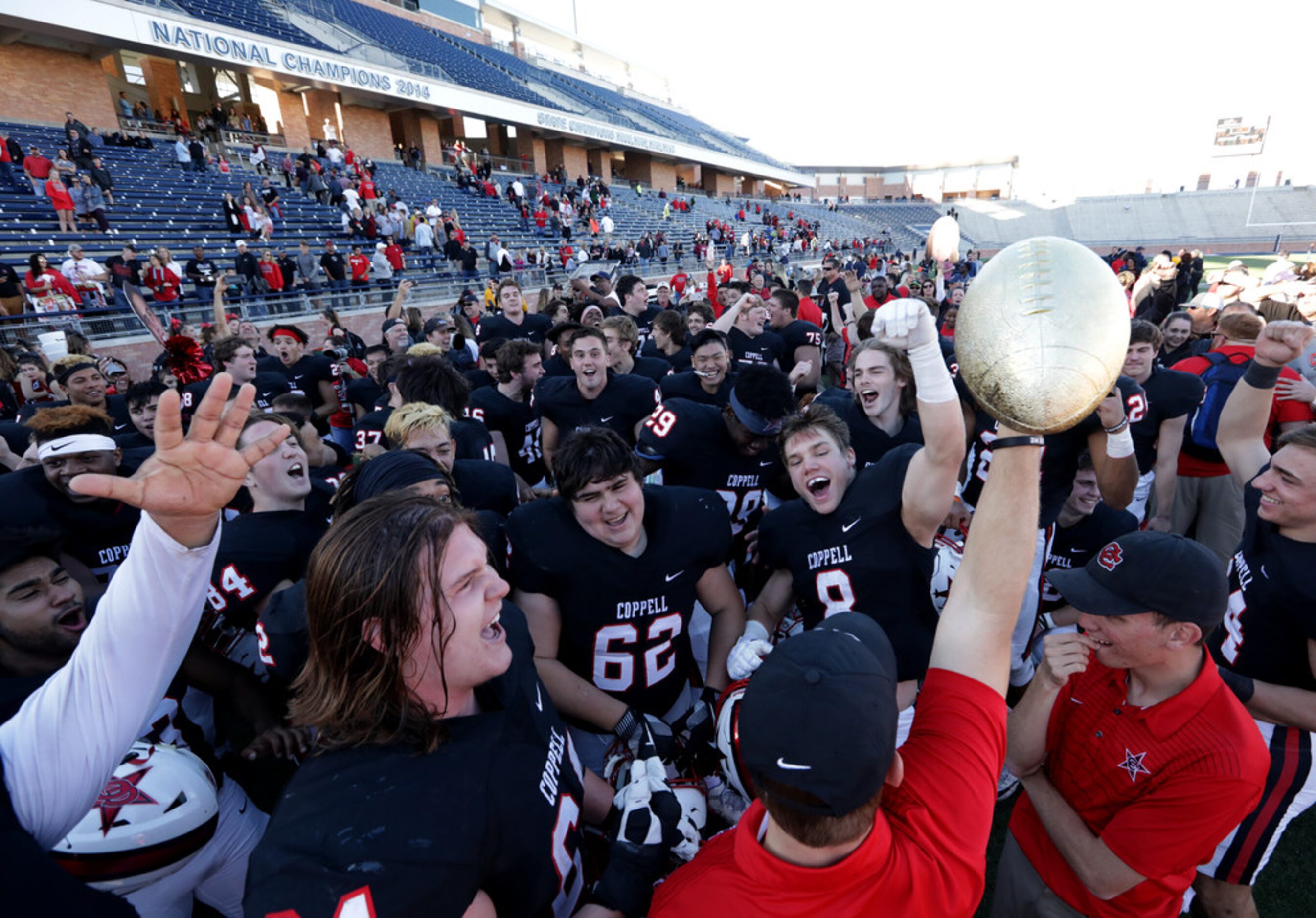 Coppell players celebrate after a win in a Class 6A division I playoff game between Coppell...