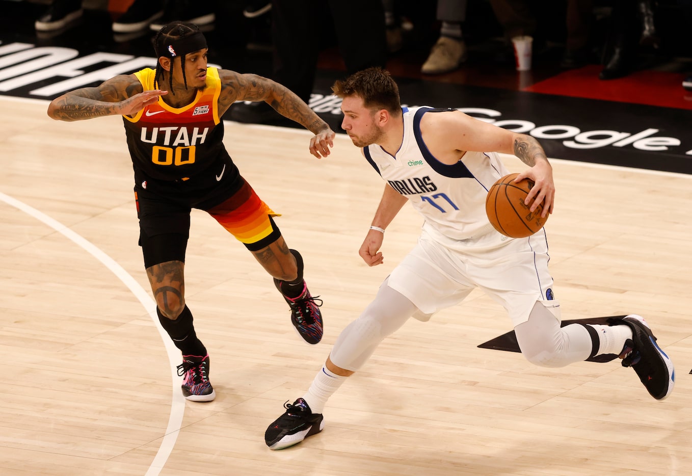 Dallas Mavericks guard Luka Doncic (77) steps back as he drives on Utah Jazz guard Jordan...