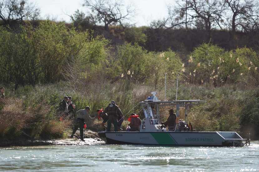 Central American immigrants are taken into custody as they cross into the U.S. from Piedras...