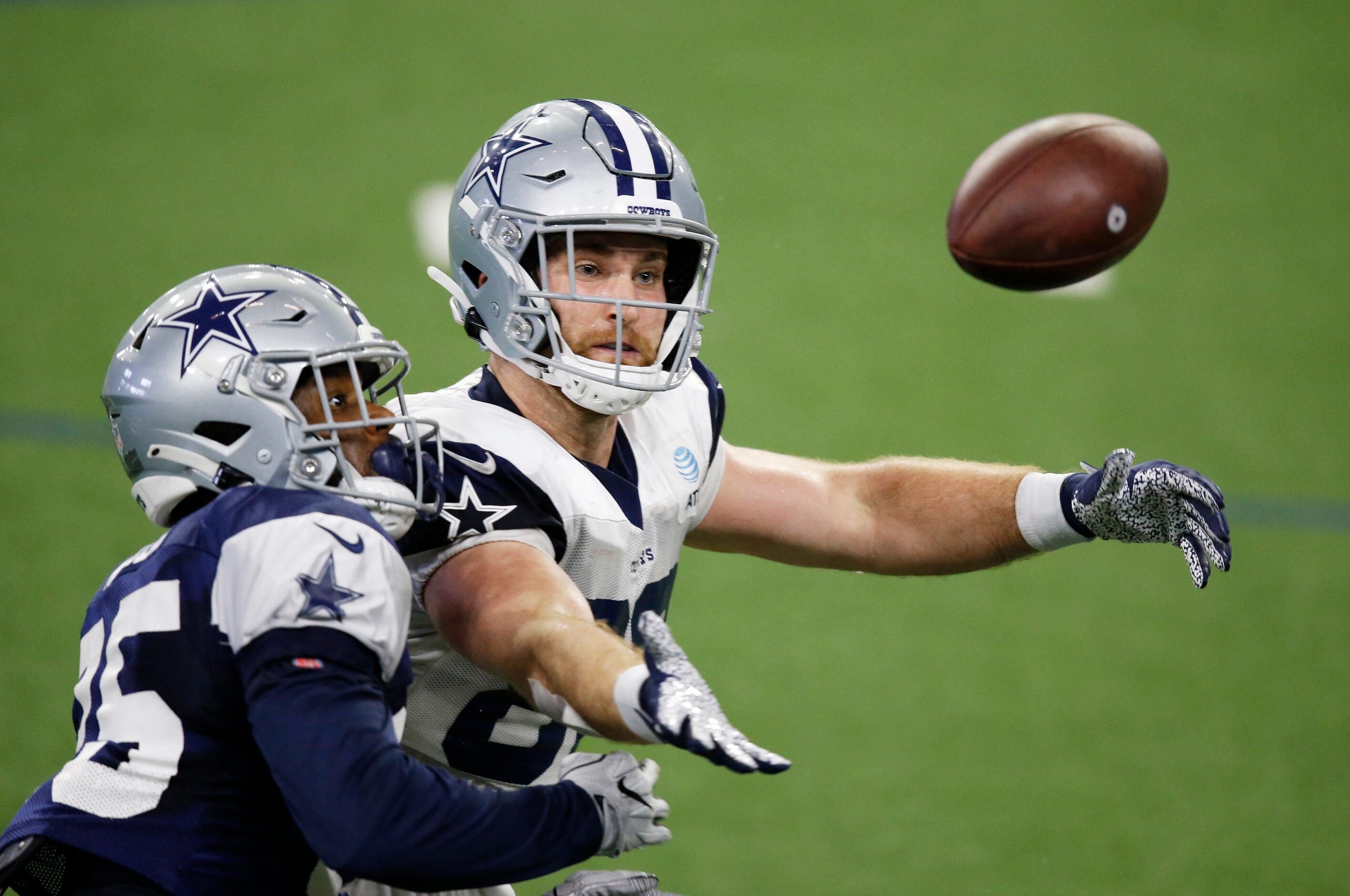 Dallas Cowboys tight end Dalton Schultz (86) and Dallas Cowboys safety Xavier Woods (25)...