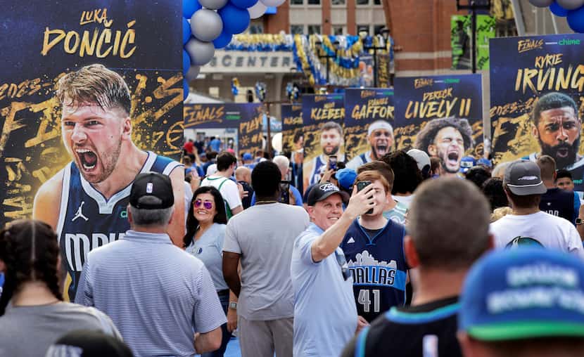 Dallas Mavericks fans arrive and take selfies before Game 3 of the NBA Finals against the...