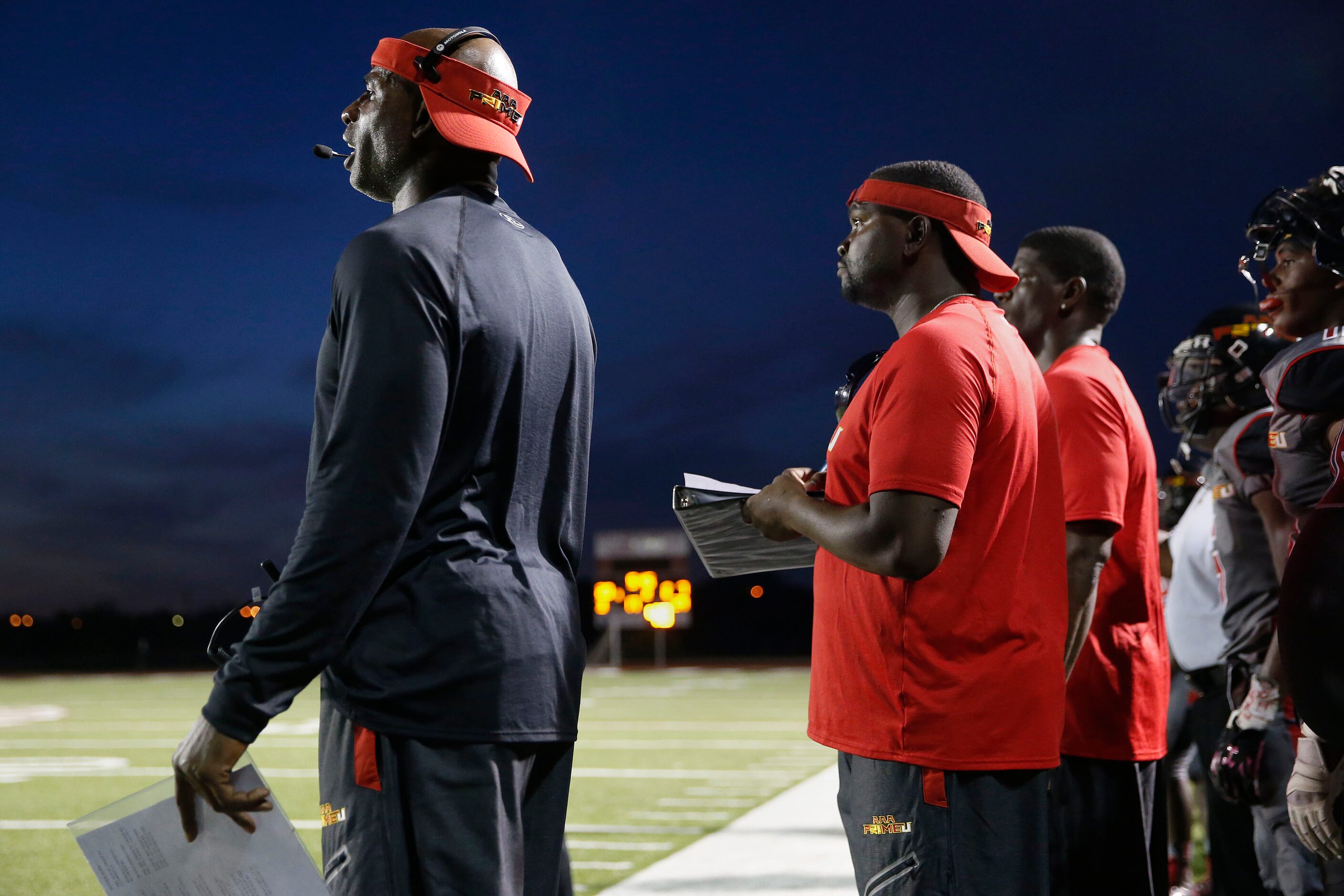 AAA Prime U coach Deion Sanders communicates with his players in the first half during a...