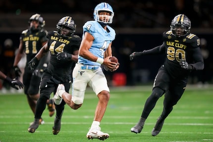 Frisco Emerson quarterback Michael Hawkins (4) races for a first down past South Oak Cliff...