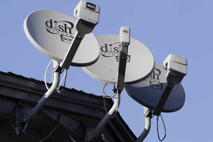 FILE - In this Feb. 23, 2011 file photo, three Dish Network satellite dishes are shown at an...