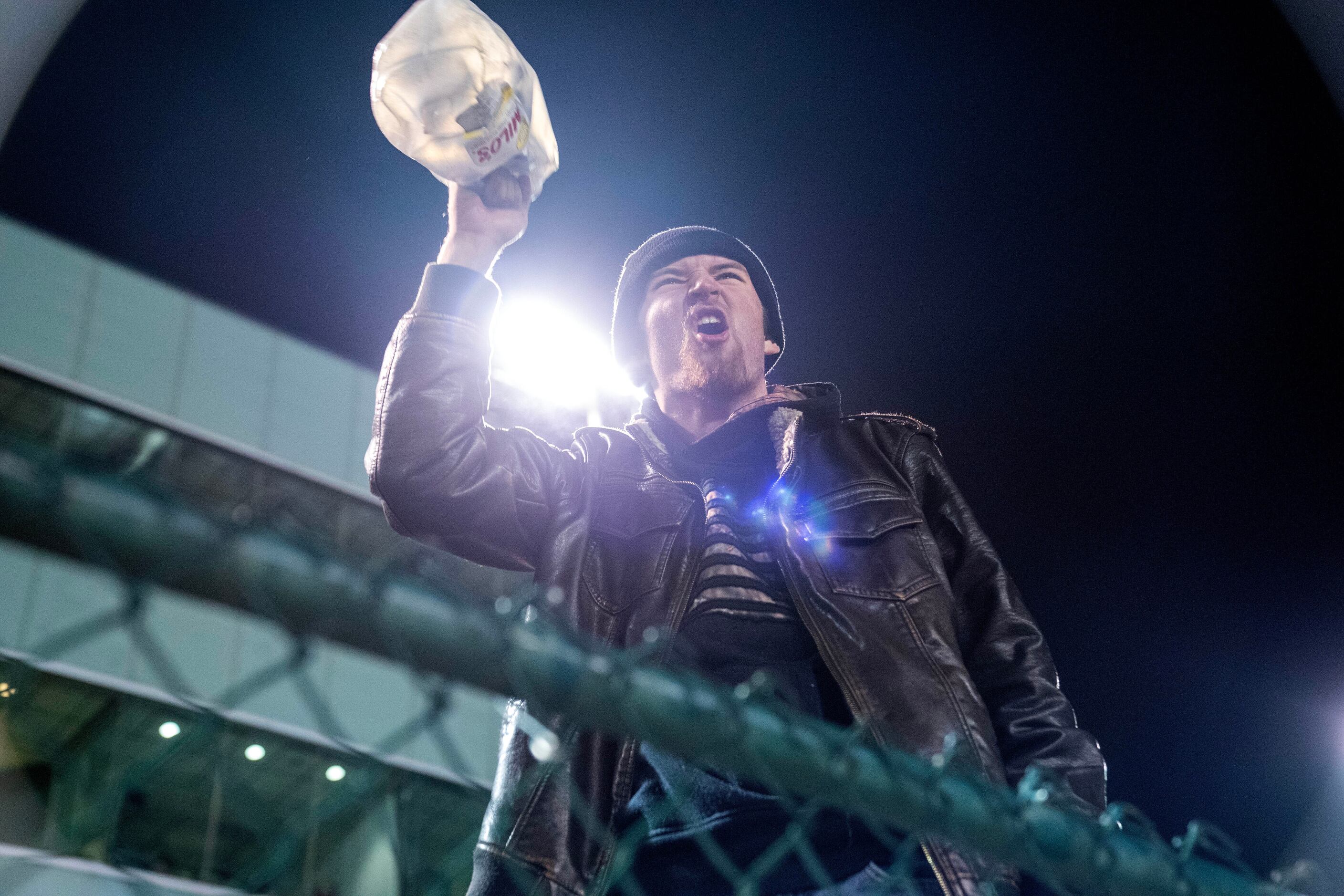 Crandall fan Alexander Moore shakes a milk jug full of coins during the second half of an...
