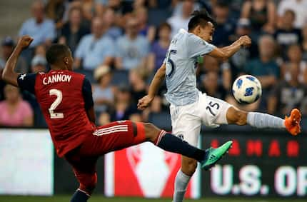 Sporting Kansas City midfielder Wan Kuzain (75) plays the ball past FC Dallas defender...