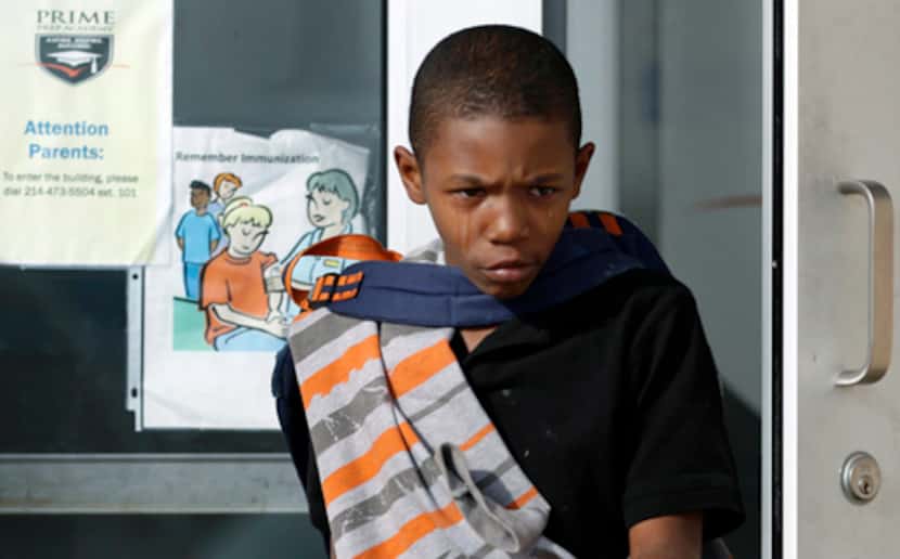 
Tears stream down the face of Demarquis Brooks, 10, as he leaves the Fort Worth campus of...