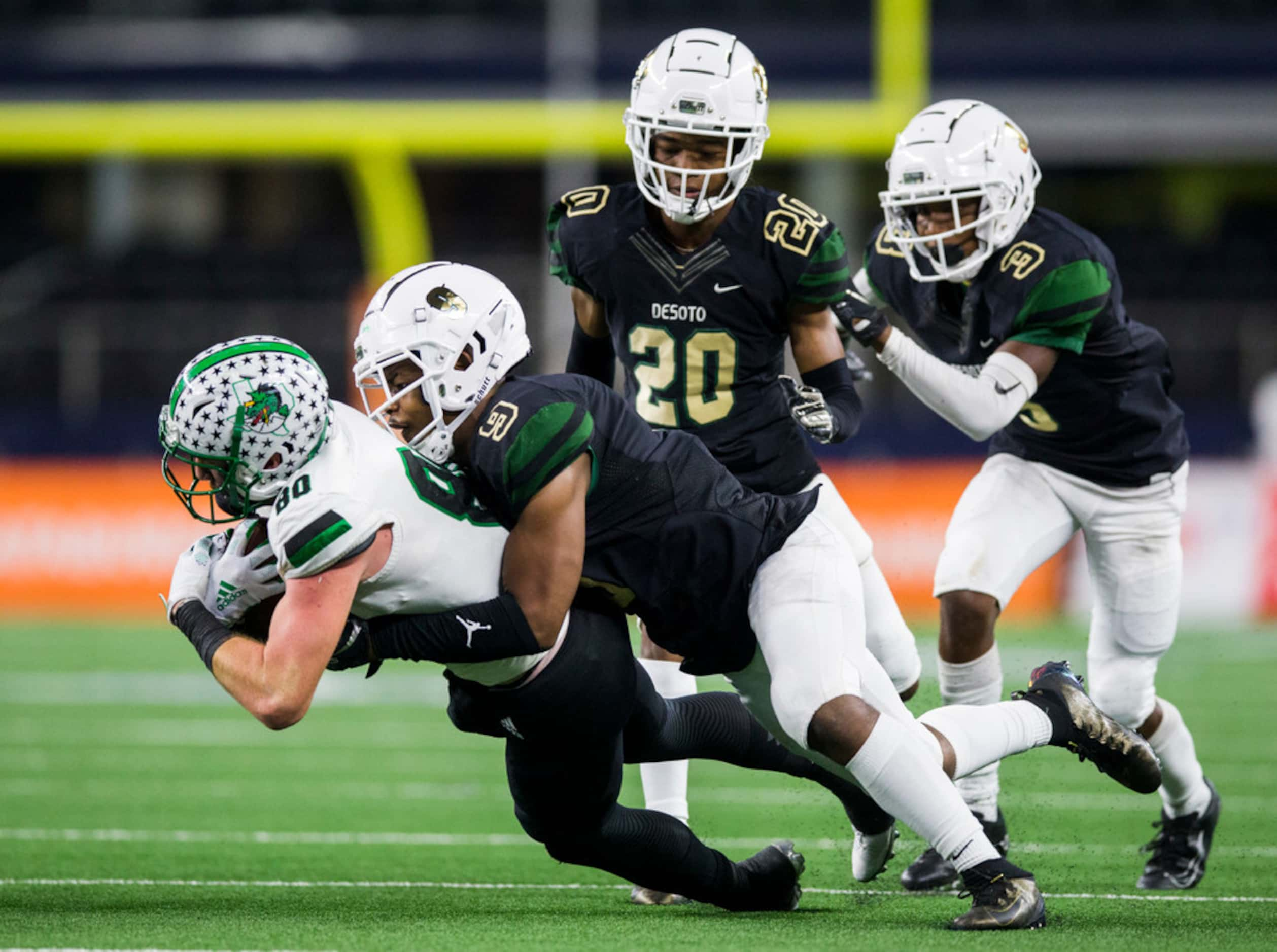 Southlake Carroll wide receiver John Manero (80) is tackled by DeSoto linebacker Ridarius...