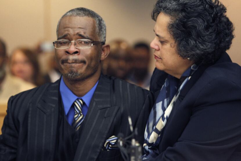 Richard Miles is comforted Wednesday by attorney Cheryl Wattley as State District Judge Andy...