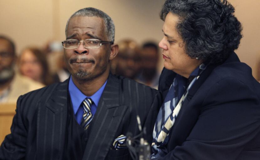 Richard Miles is comforted Wednesday by attorney Cheryl Wattley as State District Judge Andy...