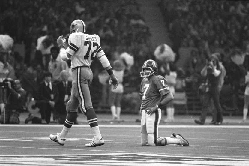 Denver Broncos quarterback Craig Morton (7) rests briefly on his knees after being sacked by...