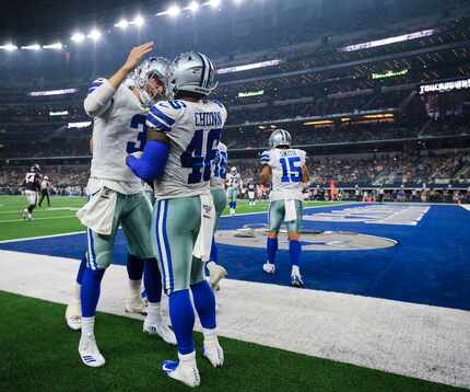 Dallas Cowboys quarterback Mike White (3) celebrates with running back Jordan Chunn (46)...