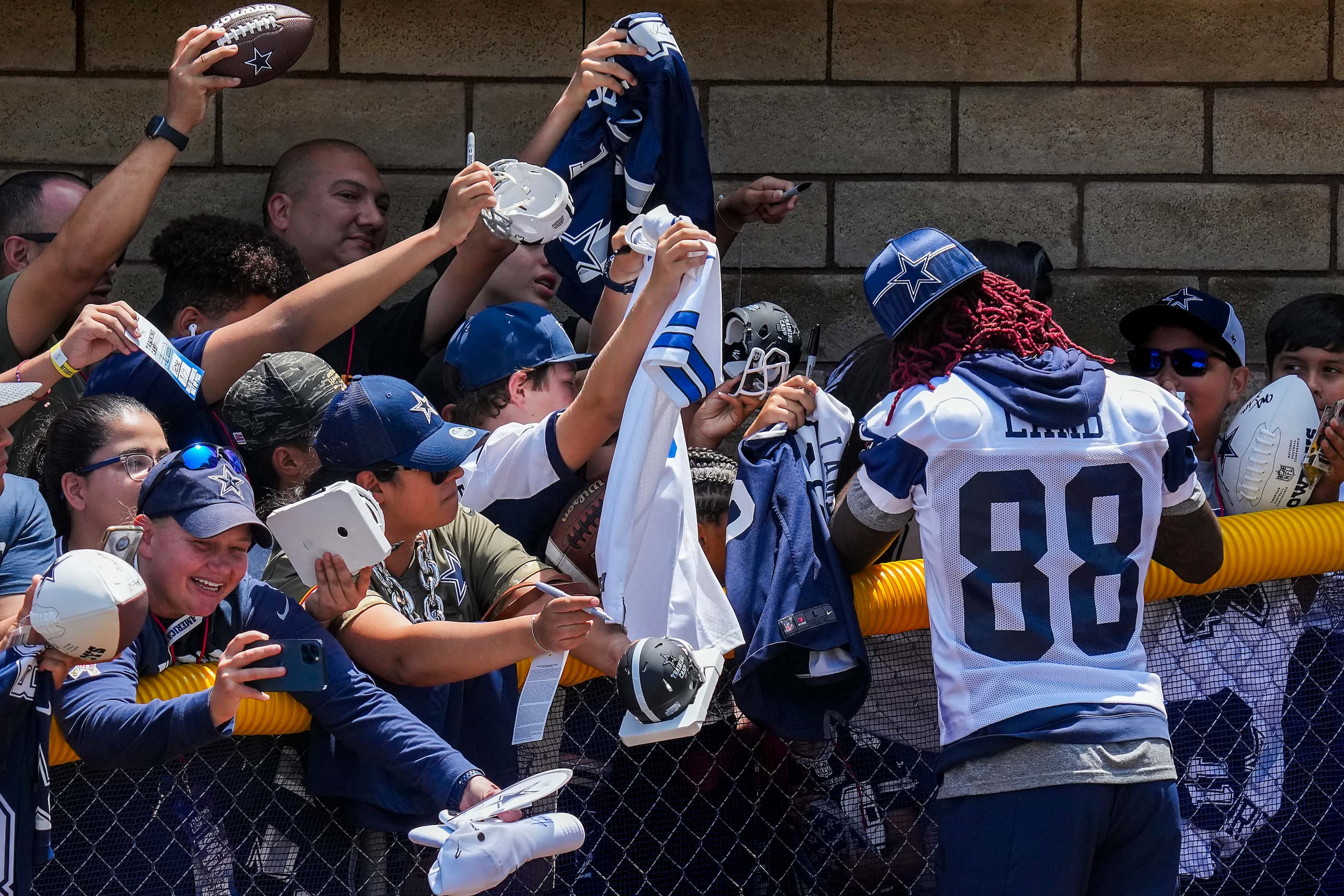 Dallas Cowboys wide receiver CeeDee Lamb  signs autographs for fans following a training...