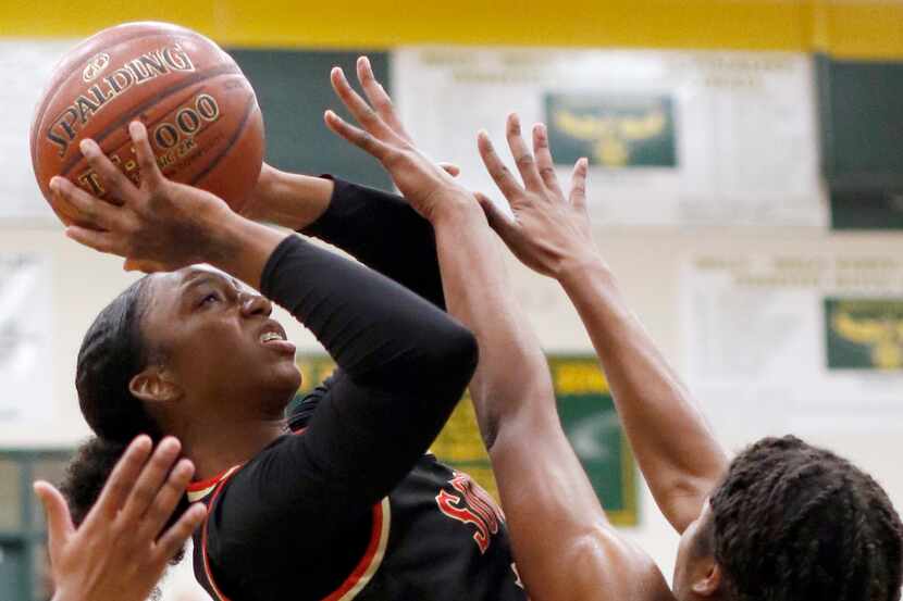 South Grand Prairie's Jahcelyn Hartfield (11) shoots against the defense of DeSoto's Ash'a...