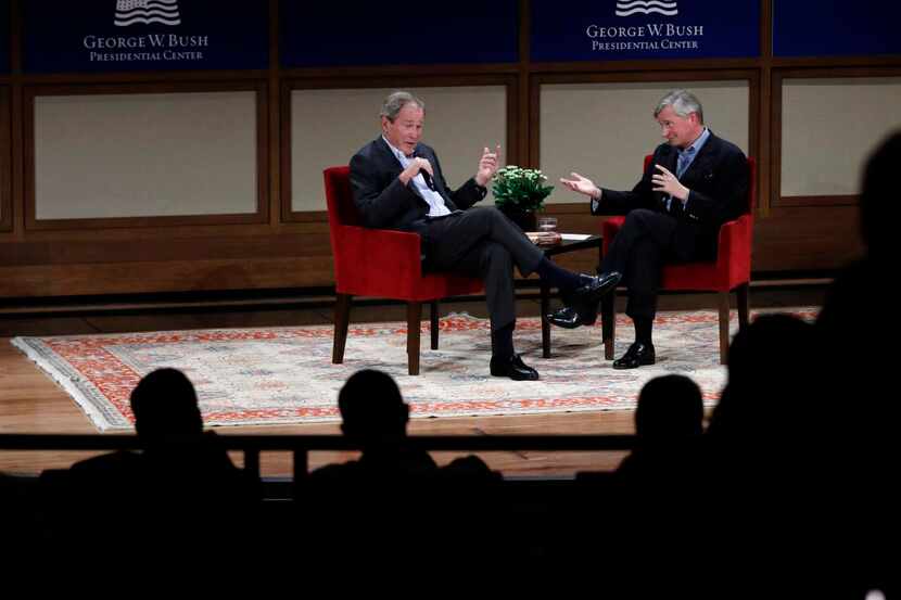 Former President George W. Bush and author Jon Meacham talk during a discussion of author...
