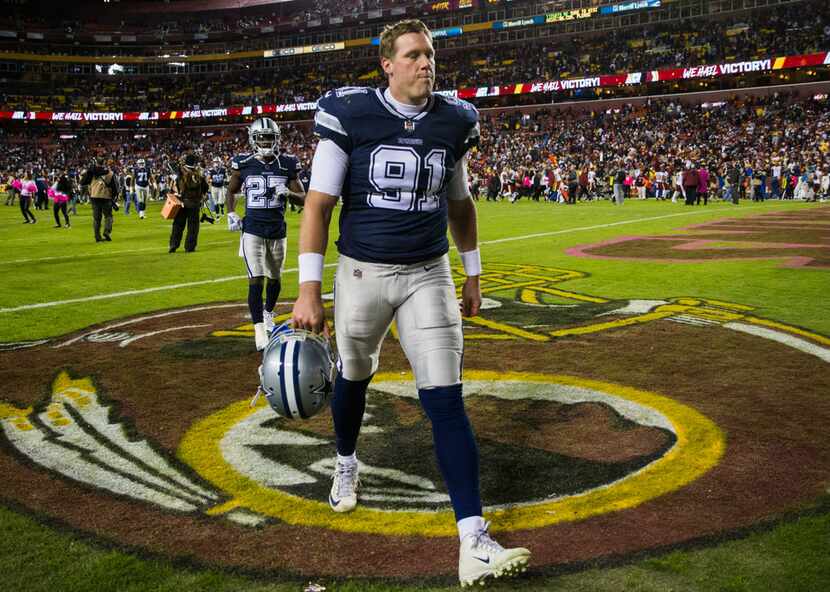 Dallas Cowboys long snapper L.P. LaDouceur (91) makes a face as he leaves the stadium after...